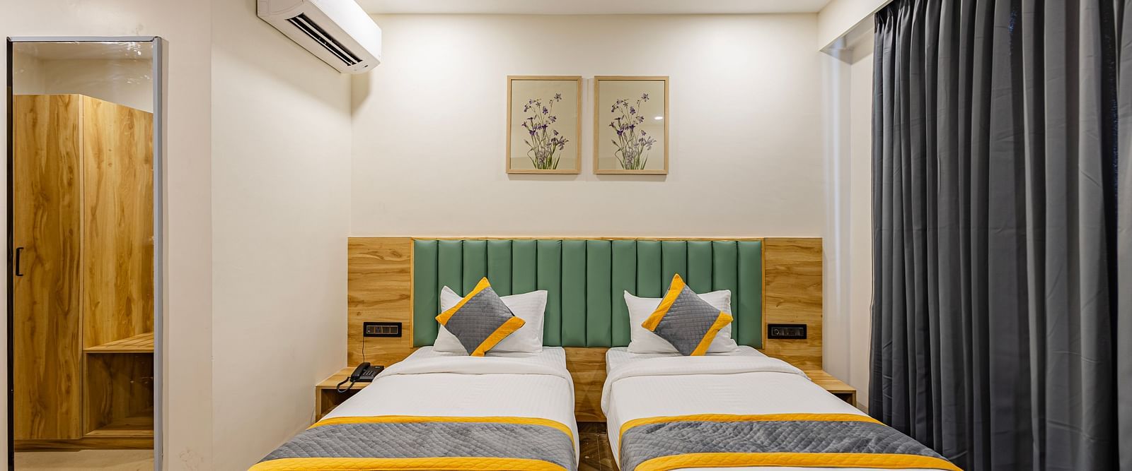 Lemonridge Hotels, KPHB |  Hotel room with two beds, separated by a small table. Simple and practical layout.